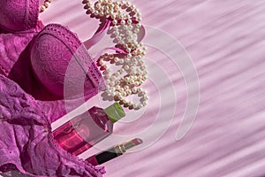 Lingerie and cosmetic on pink background