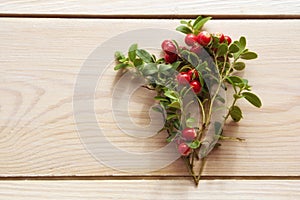 Lingonberry   cowberry , partridgeberry  on a wooden table. Top view