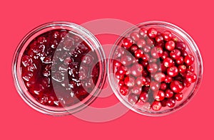 Lingonberry jam and lingonberries in glass bowls over pink