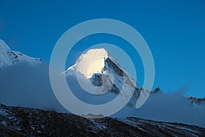 Lingtren mountain peak in Himalayas at sunset