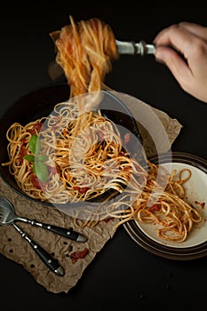 Linguine with Basil and Red Sauce in Cast Iron Pan Being Served