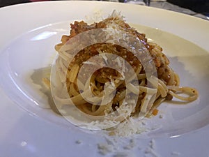 Linguini Bolognese with cheese . Top view