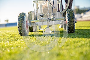 Lining a football pitch using white paint on grass