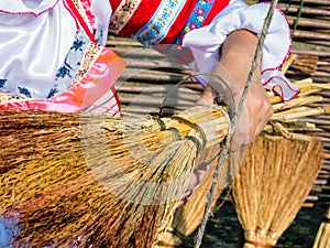 Linking a homemade sorghum broom with a rope