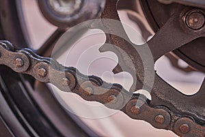 Links of a chain of a motorcycle with traces of lubricant and dirt