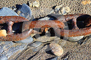 Links In the Chain - Rusty Boat Chain On The Beach