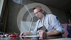 Linocut handmade artist in eyeglasses and apron making sketch