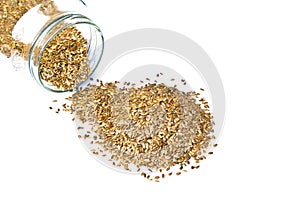 Linseed or Flex Seeds pouring from a glass jar