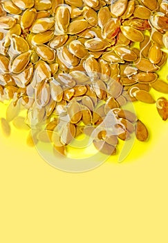 Linseeds or flax seeds in the olive oil on yellow backround. Polyunsaturated fatty acids omega 3-6-9 vitamin