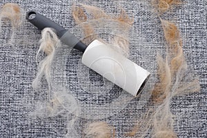 A lint roller with animal fur and fluff on it