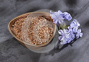 Linum usitatissimum - Organic flax seeds in the wooden bowl