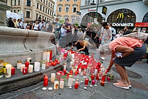 flowers and burning candles lie at a memorial in memory of upper austrian doctor Lisa-Maria Kellermayr