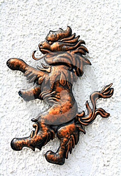 Lion bronze figure on the white wall