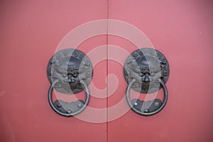 Lion head door knob with red  wooden door