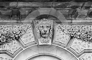 Lion head relief on the facade of building. London, England