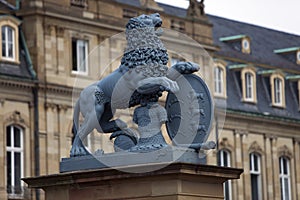 Lion sculpture with crest in front of the main entrance of the New Castle Neues Schloss in Germany, Stuttgart