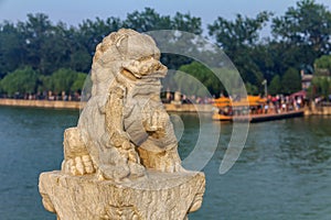 Lion sculpture at the famous 17 arch lion bridge on Kunming Lake