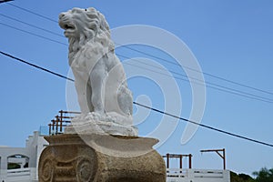 A lion sculpture stands on a stone column in Pefki, Rhodes Island, Greece