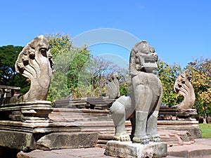 Lion and Seven Headed Naga Sculptures under Vivid Blue Sky, the Entrance of Phimai Historical Park in Nakhon Ratchasima