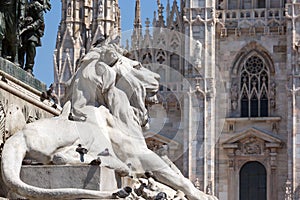 Lion statue and cathedral in Milan
