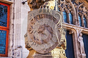 Lion statue with coat of arms shield.
