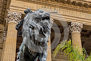 Lion statue in front of the Theater Massimo Vittorio Emanuele in Palermo, Italy.