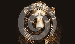 Lion statue, a gold sculpture. Concept of a guard, power and proud animal