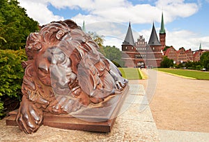 Lion statue and Holstein Gate at Lubeck