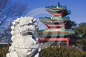 A Lion Statue Keeps Watch over an Asian-Style Building at Robert D. Ray Asian Gardens in Des Moines, Iowa