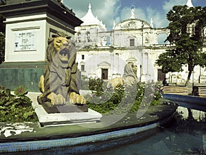 Lion statues Parque Central with Cathedral Leon in background Ni