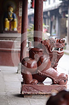 A lion under the column of a Chinese Temple