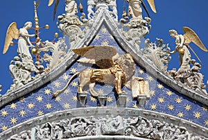 Lion with wings made of gold on the facade of the Basilica of Sa