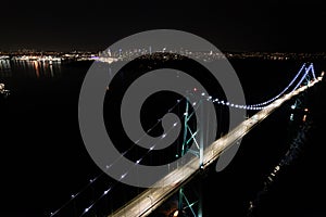 Lions Gate Bridge aerial, night, car light trails, traffic, Vancouver, BC, Canada.