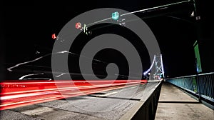 Lions Gate Bridge at night, car light trails, traffic, Vancouver, BC, Canada.