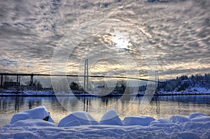 Lions Gate Bridge with sun and clouds in winter.