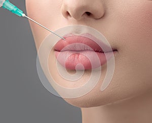 Lip filler injections. Fillers. Lip augmentation Beautiful Perfect Lips with hyaluronic acid. Sexy Mouth close-up. Beauty lips