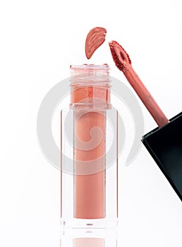 Lip Gloss with application brush on white background