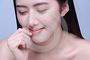 Lip Protection. Closeup of Beautiful Young Asian Woman Healthy Lips. Female Model Touching Her Plush Mouth With Smooth Perfect