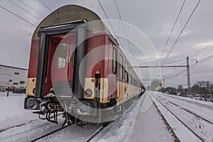 Lipany station in winter snow morning with trains and platforms