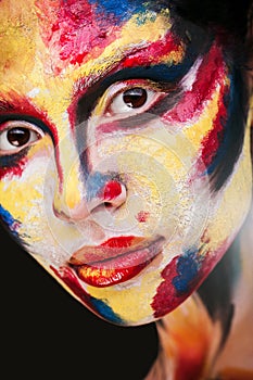 Lips of beautiful young girl with paint on his face