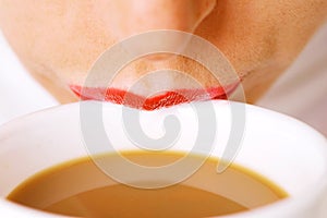 Lips on cup of coffee with milk