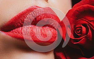 Lips with lipstick closeup. Beauty Red Lips Makeup Detail. Beautiful woman lips with rose.