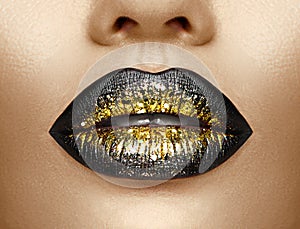 Lips makeup. Beauty high fashion gradient lips makeup sample, black with golden color. mouth. Lipstick