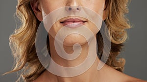 Lips of mature woman, skincare beauty and face of senior model with smooth skin against a grey studio mockup background