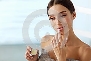 Lips Skin Care. Woman With Beauty Face Applying Lip Balm On