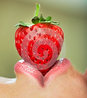 Lips with strawberry.