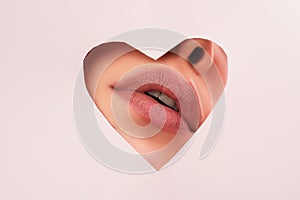 Lipscare. Nude makeup. Woman lip through hole in paper. Copy Space for advertising. Fashion beauty. Make-up and