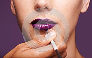 Lipstick, beauty and mouth of woman on purple background for makeup, cosmetics and products. Salon aesthetic, creative