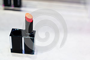 The lipstick in the black suqare shape container