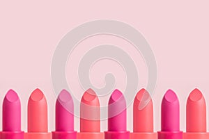 Lipstick border on pink background with copy space.